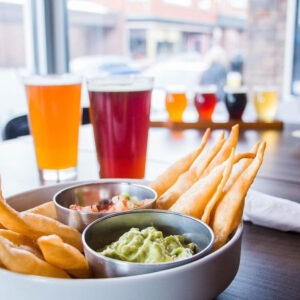 The snack bar chips and dip image with drinks in the background