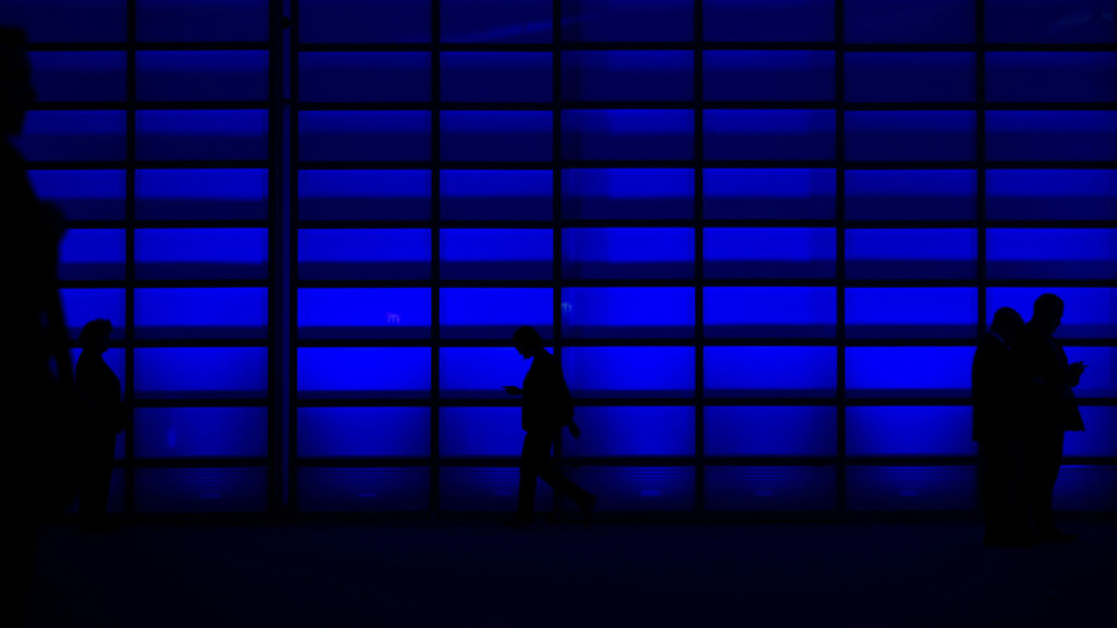 Vibrant wall with people walking through to set the scene